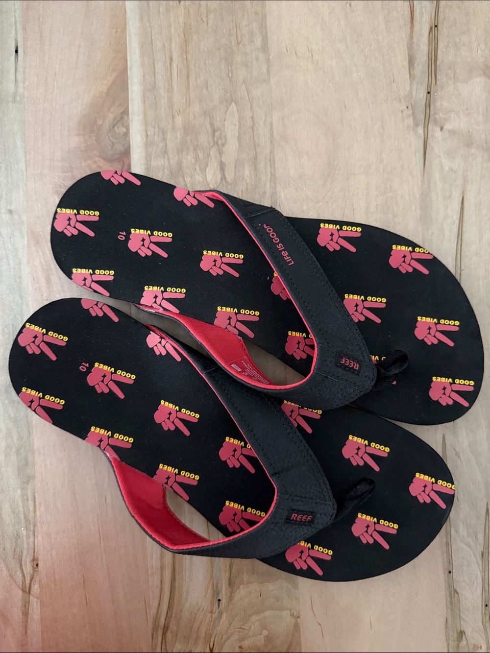 Reef Black Flip Flops with Red and Yellow Graphic Print